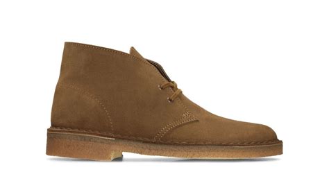 Stylish and versatile, the original Desert Boot from Clarks launched in 1950 by Nathan Clark and was inspired by a rough boot from Cairo's Old Bazaar. An instant hit, it became the footwear of choice for off-duty army officers. A premium brown suede upper is teamed with an unfussy lace fastening and our signature crepe sole.
